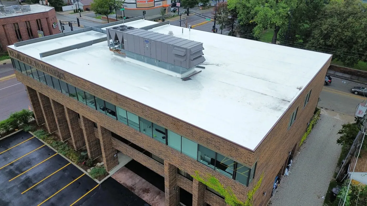 Aerial view of completed white TPO roof on commercial office building