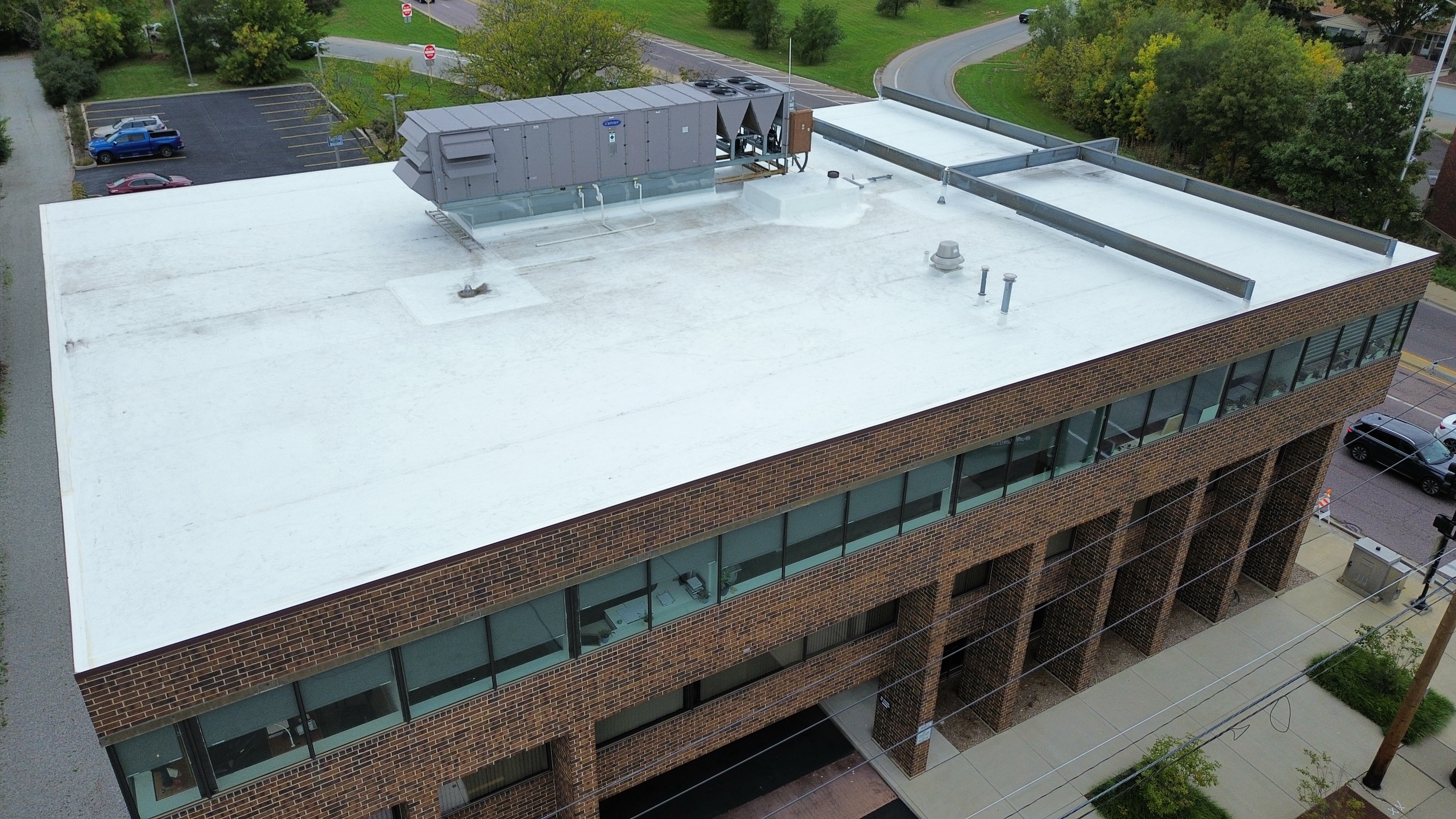 After: Completed white TPO roof on commercial office building