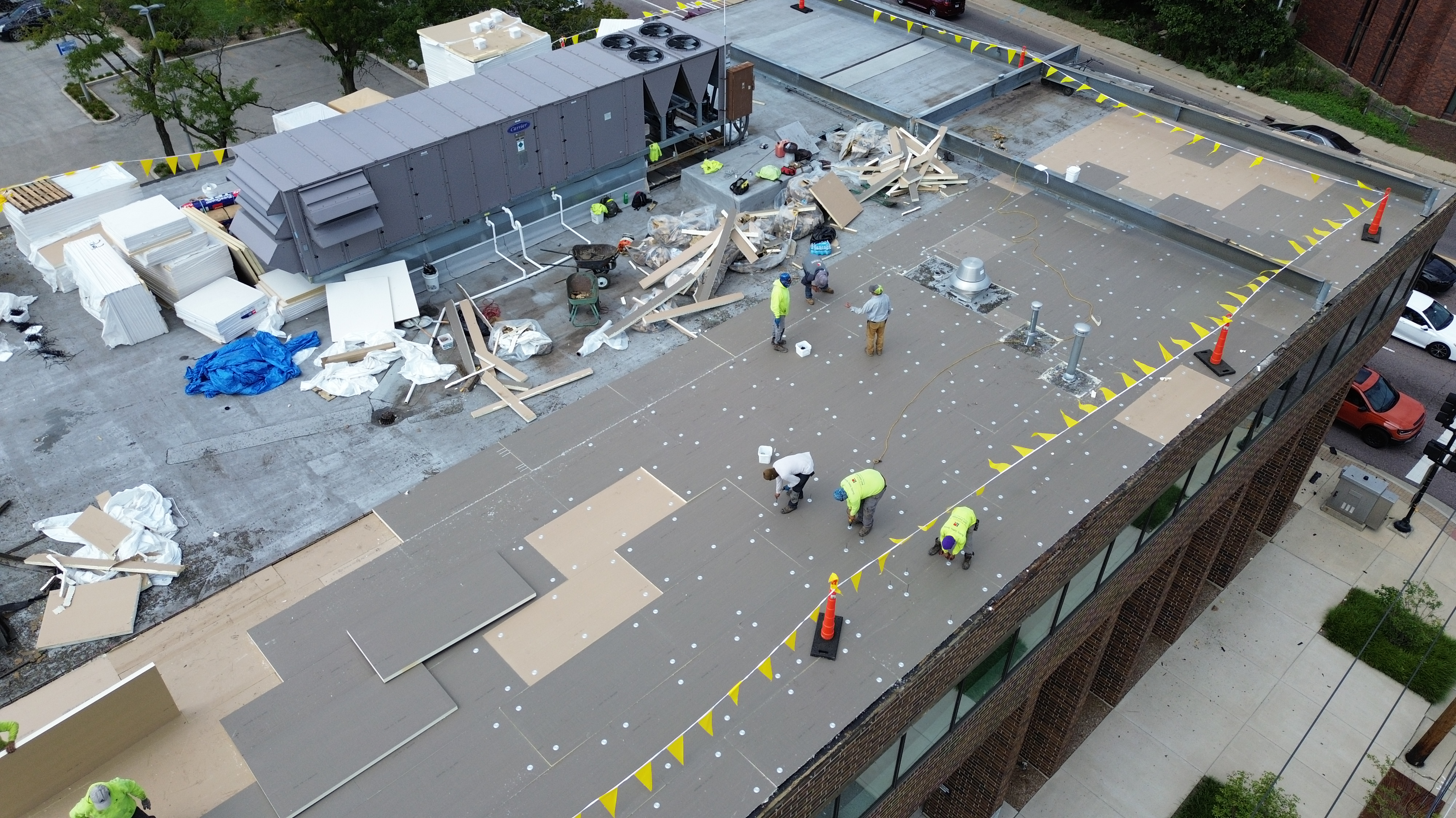 Before: Crew installing insulation and membrane on commercial office building roof