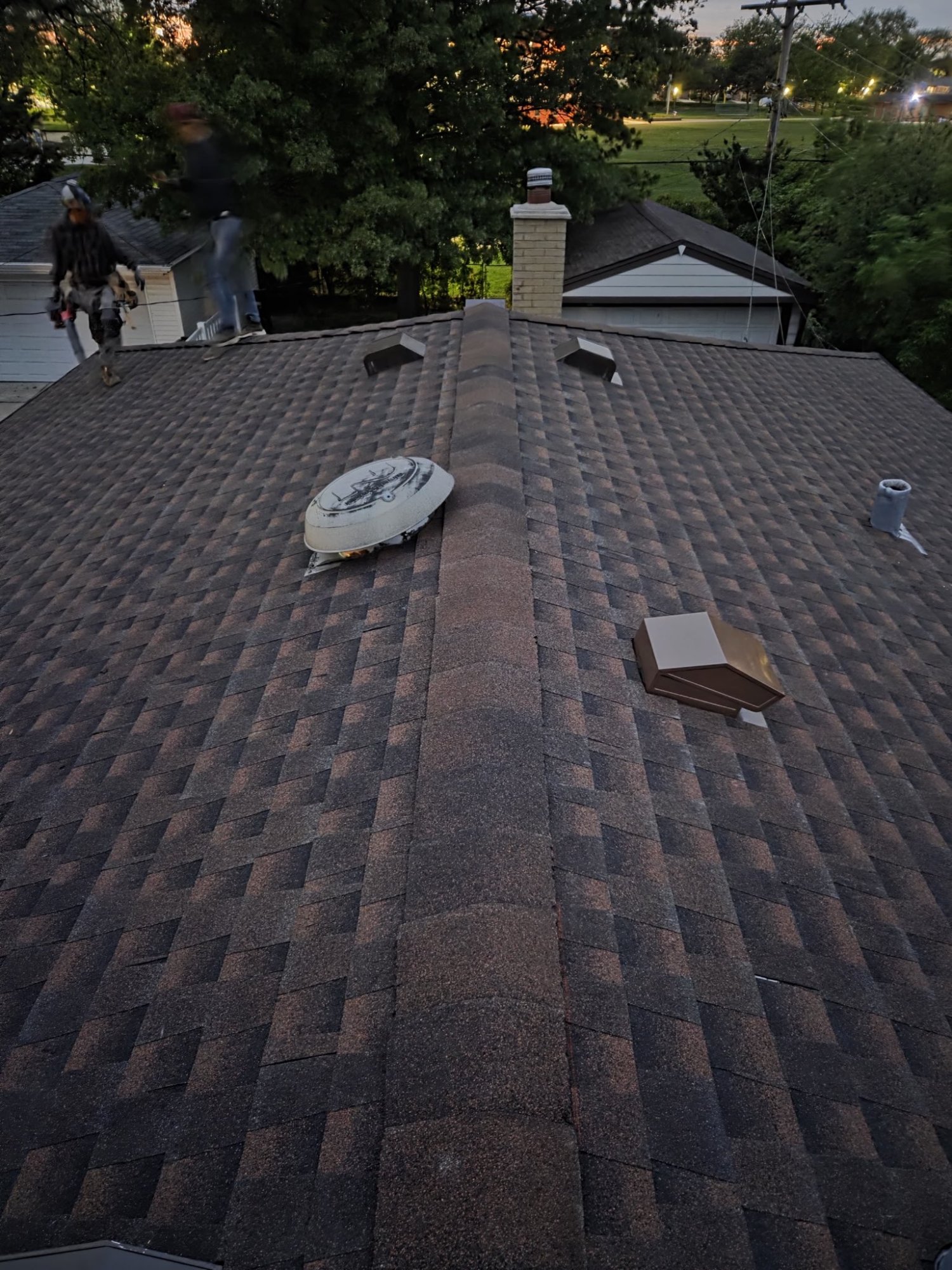 Completed residential roof ridge line with vents