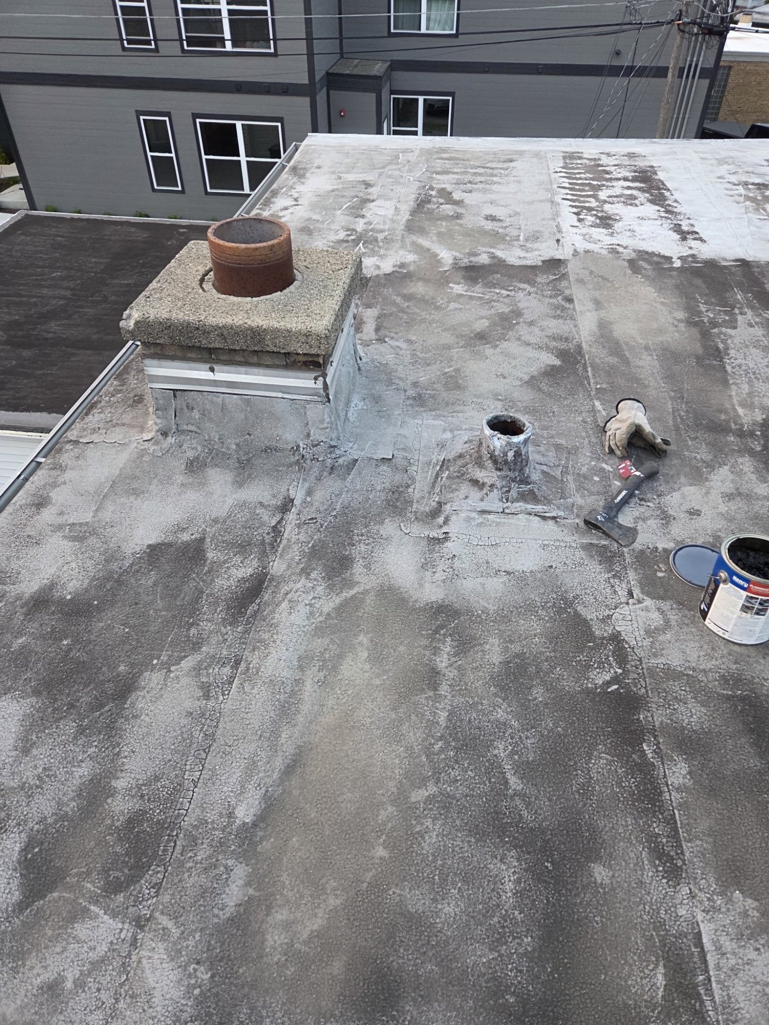 Flat roof repair with chimney masonry work