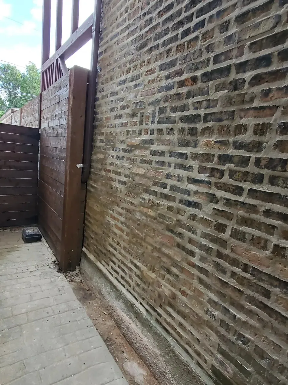 Brick wall tuckpointing and masonry restoration on Chicago building