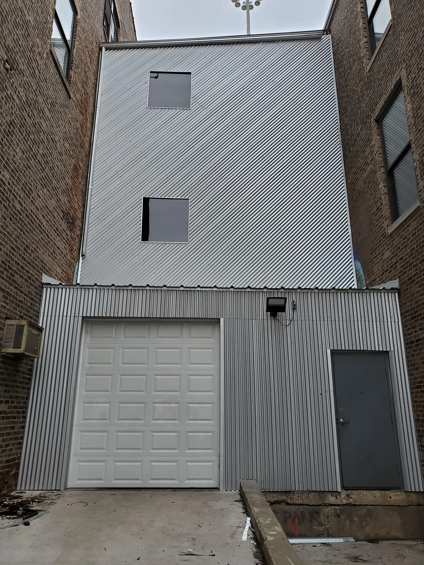 Corrugated metal siding and roofing installation on commercial building