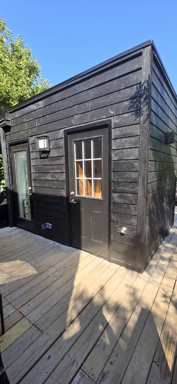 Dark Hardie board siding installation with deck