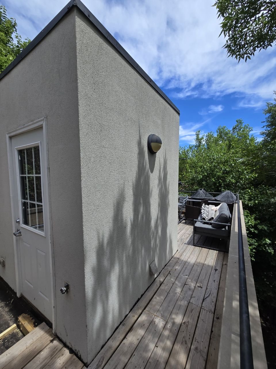 Finished stucco exterior with rooftop deck