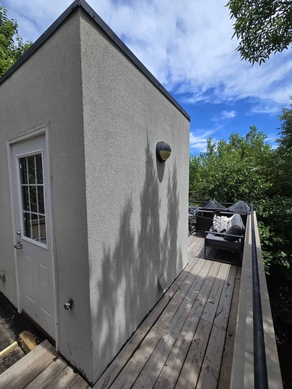 Finished stucco exterior with rooftop deck
